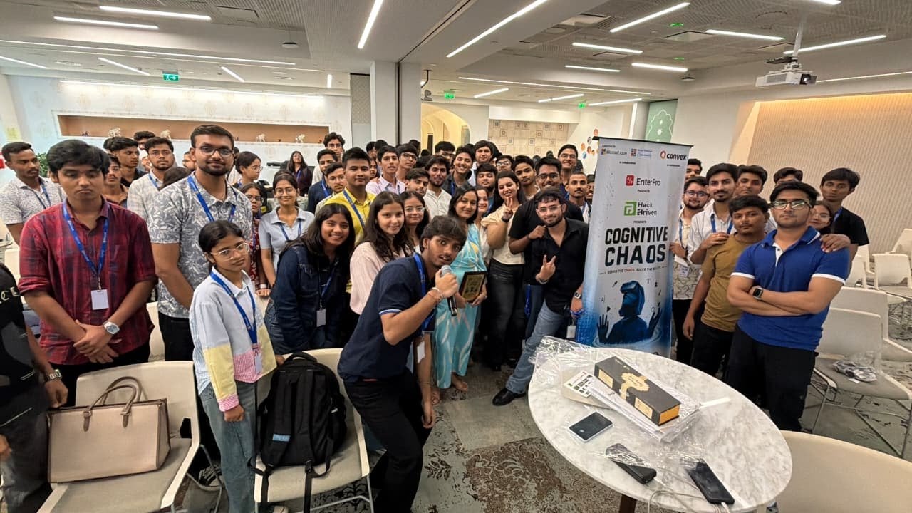 Cognitive Chaos 2026 participants pose together beside the event banner at the Microsoft India (R&D) office in Noida.